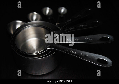 A Set of Black Measuring Spoon on Black Background Stock Photo - Image of  group, kitchenware: 176742908