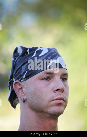 young Montana tattooed cowboy in blue camouflage bandanna Stock Photo