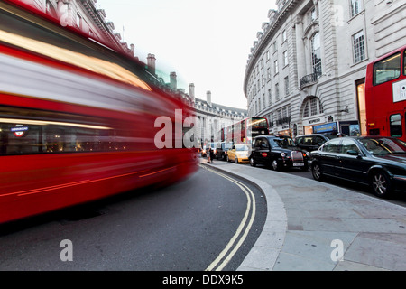 A London Bus traveling along Regent Street, on a late summers evening, blurred as it moves. Stock Photo