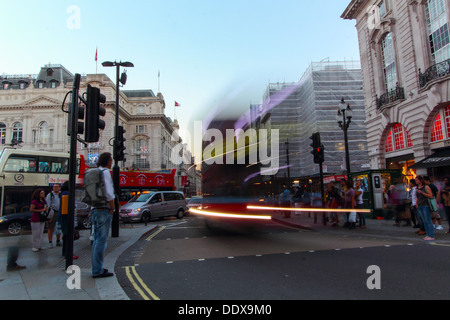 A London Bus traveling along Regent Street, on a late summers evening, blurred as it moves. Stock Photo