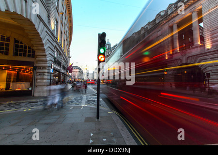 A London Bus traveling along Regent Street, on a late summers evening, blurred as it moves. Stock Photo