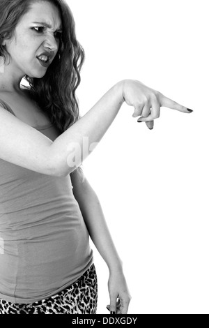 Model Released. Frustrated Young Woman Pointing Finger Stock Photo