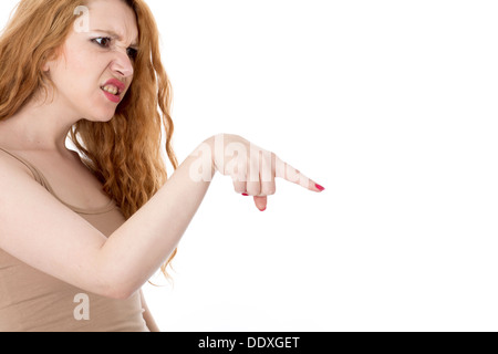 Model Released. Frustrated Young Woman Pointing Finger Stock Photo