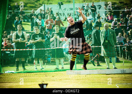 Braemar, Scotland, United Kingdom. September 7th, 2013: An athlete competes in the hammer throwing at the annual Braemer Highland Games at The Princess Royal and Duke of Fife Memorial Park Stock Photo