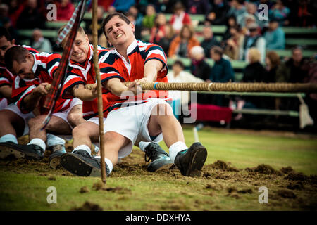 Braemar, Scotland, United Kingdom. September 7th, 2013: A team fights in the tug war competition  during the annual Braemer Highland Games at The Princess Royal and Duke of Fife Memorial Park Stock Photo