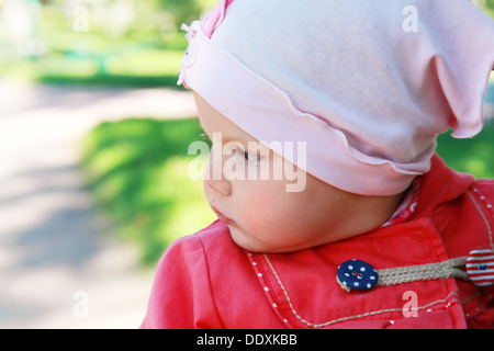 Little baby girl in the park, closeup portrait Stock Photo