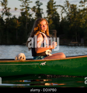 Girl boating in a lake, Lake of The Woods, Keewatin, Ontario, Canada Stock Photo