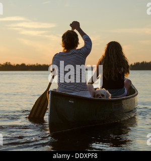 Woman rowing a boat with her daughter, Lake of The Woods, Keewatin, Ontario, Canada Stock Photo