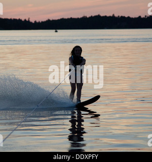 Girl water skiing in a lake, Lake of The Woods, Keewatin, Ontario, Canada Stock Photo