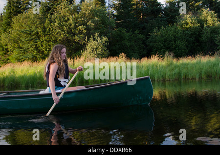 Girl boating in a lake, Lake of The Woods, Keewatin, Ontario, Canada Stock Photo