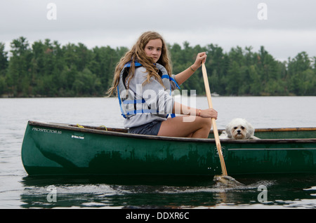 Girl boating in a lake, Lake of The Woods, Keewatin, Ontario, Canada Stock Photo