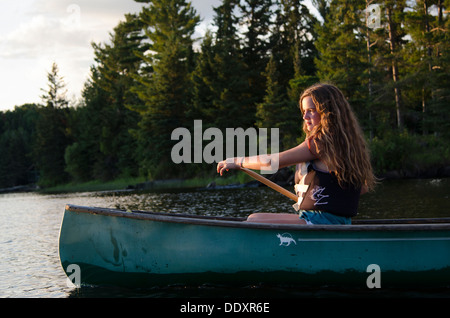 Girl boating in a lake, Lake of The Woods, Keewatin, Ontario, Canada Stock Photo