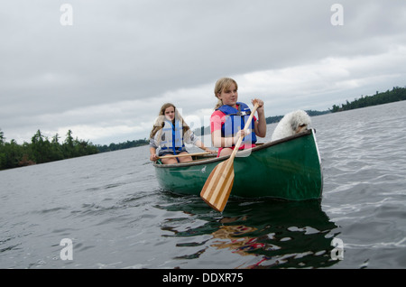 Girls boating in a lake, Lake of The Woods, Keewatin, Ontario, Canada Stock Photo