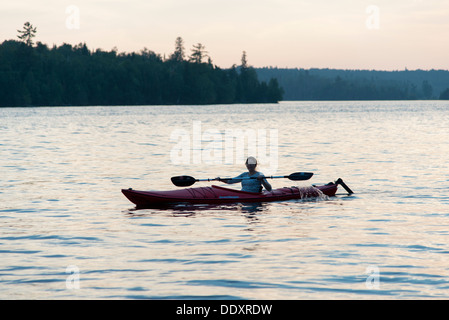 Woman kayaking in a lake, Lake of The Woods, Keewatin, Ontario, Canada Stock Photo