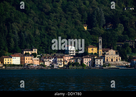 Village of Porto Ceresio with the Parish Church of Chiesa Sancto Ambrosio on Lake Lugano or Lago di Lugano Stock Photo