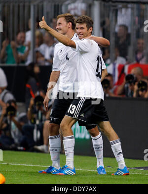 Germanys Thomas Muller (L) celebrates scoring the 3:0 with Benedikt Höwedes during the soccer match for the qualification of the world cup between Germany and Autria, Allianz Arena in Munich on September 06. 2013. Stock Photo