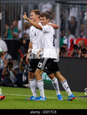 Germanys Thomas Muller (R) celebrates scoring the 3:0 with Benedikt Höwedes during the soccer match for the qualification of the world cup between Germany and Autria, Allianz Arena in Munich on September 06. 2013. Stock Photo
