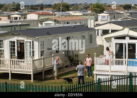 Static caravan holiday homes chalets, permanent camp site St Osyth Essex UK. Families family chatting  St Osyth Beach Holiday Home Park. September 2013 2010s HOMER SYKES Stock Photo