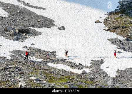 Hikers on the Eiger Trail near Grindelwald Switzerland. The trail runs directly below the North Face of the Eiger Stock Photo