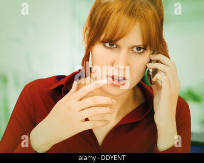 Gesticulating, angry businesswoman with a mobile phone Stock Photo