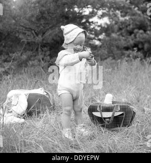 A little girl has found the picnic basket, Sweden, 1955. Artist: Unknown Stock Photo