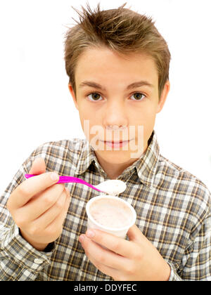 Portrait, boy, teenager eating yoghurt Stock Photo