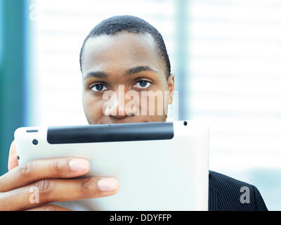 Young businessman, African-American, American, respectable, focused, looking at his iPad Stock Photo