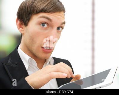 Businessman working on an iPad, focused, stressed, portrait Stock Photo