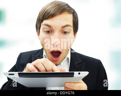 Businessman working on an iPad, focused, amazed, surprised, portrait Stock Photo