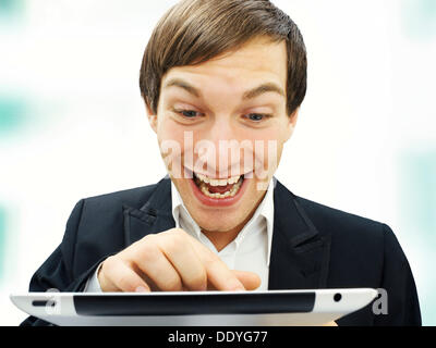 Businessman working on an iPad, focused, happy, portrait Stock Photo