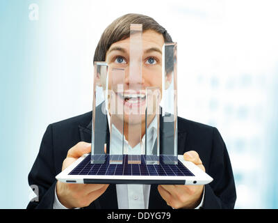 Happy businessman holding an iPad with a glassy bar chart, symbolic image for economy, growth, profit, economic recovery Stock Photo