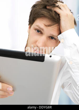Portrait of a businessman, iPad, thoughtful, focused, reflective, hand on head Stock Photo