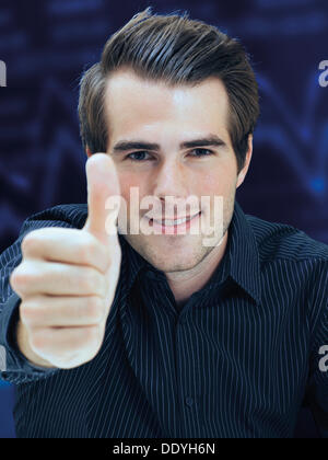 Businessman giving thumbs-up Stock Photo