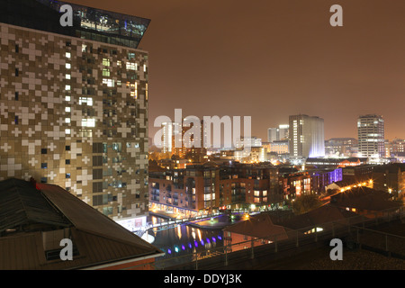 The Cube building and cityscape of Birmingham at night, West Midlands, England, UK Stock Photo