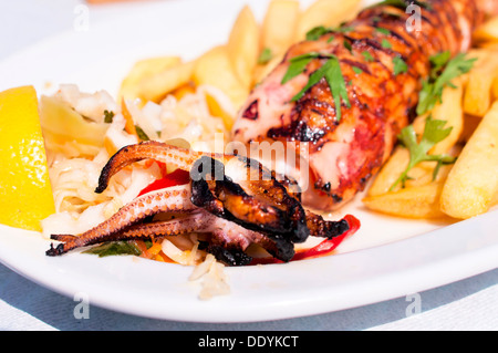 Grilled stuffed squid with vegetables and feta cheese Stock Photo