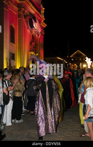 Parade of mask wearers in front of the historic municipal church, Venetian Fair, on the historic Marktplatz market square Stock Photo