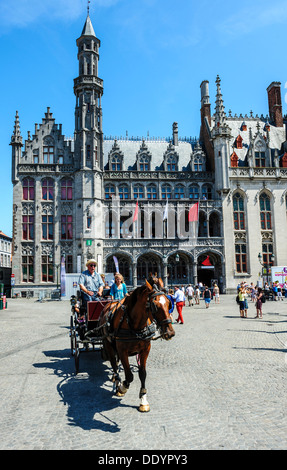 Horse drawn carriage carrying tourists in Grote Markt, Bruges, Belgium Stock Photo