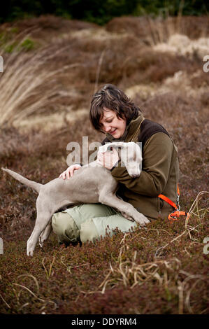 Huntress with Weimaraner puppy Stock Photo