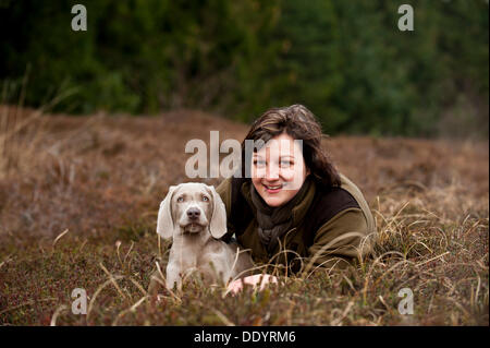 Huntress with Weimaraner puppy, portrait Stock Photo