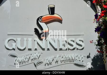 Guinness toucan advert painted on a pub window, London, UK Stock Photo