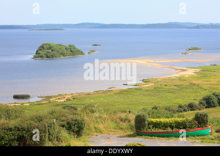 Moored colorful wooden fishing boats along Lough Mask in Tourmakeady, Ireland Stock Photo
