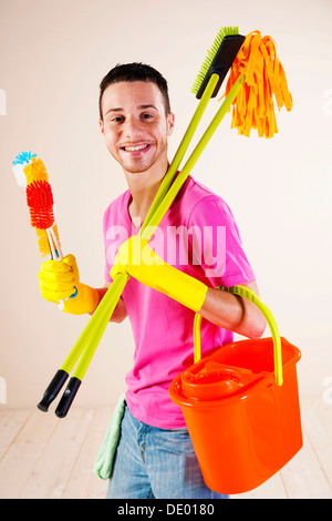 Man holding cleaning products in his hands Stock Photo