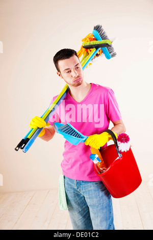 Man holding cleaning products in his hands Stock Photo