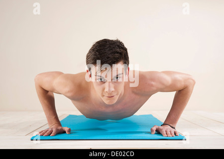 Young man doing pushups Stock Photo