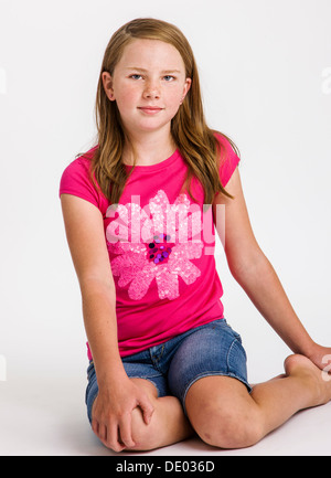 Studio portrait of cute red haired ten year old girl Stock Photo