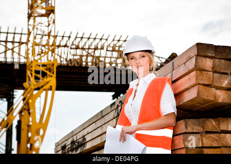 A young female constructor at building of a new motorway Stock Photo