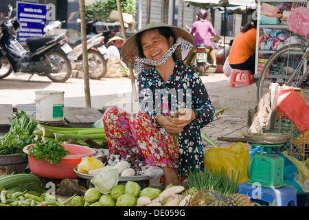 Market vendor selling goods at the market in Cai Be, Mekong Delta, Vietnam, Southeast Asia Stock Photo