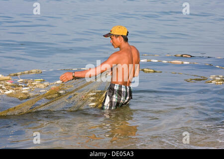 Fisherman catching fish with a fishing net in the sea, Phu Quoc Island, Vietnam, Southeast Asia Stock Photo