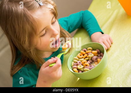 Young girl eating cornflakes from the bowl Stock Photo