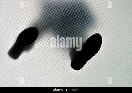 Anonymous person standing with feet wide apart, from below Stock Photo